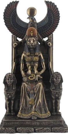 an egyptian statue sitting on top of a chair with two sphinxs around its neck