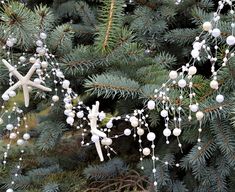 christmas decorations hanging from the branches of a pine tree