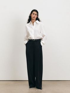 These One Tuck Semi Wide Trousers offer a modern interpretation of classic tailoring. The single tuck detail at the waist creates a subtle fullness, leading down to a semi-wide leg that provides a contemporary silhouette. These trousers are a versatile garment, easily styled for both formal and casual occasions. - The One Tuck Semi Wide Trousers feature a mid-rise waist, flattering for various body types.- Constructed from a premium fabric, they drape elegantly while offering long-lasting wear.- The semi-wide leg cut strikes a balance between trend-forward styling and timeless appeal.- Equipped with side pockets and a clean zip fly closure, these trousers are as practical as they are fashionable. Classic Tailoring, Wide Trousers, Modern Minimalism, Fitted Trousers, Oversized Silhouette, Formal Shirts, Body Types, Workout Shirts, Breathable Fabric