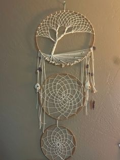 a white dream catcher hanging on the wall