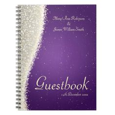 a purple and white wedding guest book with sparkles on the cover, in front of a