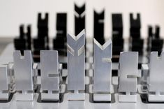 the letters are made out of metal parts and have different designs on them, including black and white ones