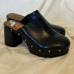 Size 11 Never Worn Heeled Clogs Black Wedge Heel Clogs For Spring, Trendy Synthetic Mules With Wooden Heel, Black High Heel Clogs For Spring, Trendy Block Heel Clogs With Removable Insole, Trendy Clogs With Removable Insole And Block Heel, Chic Synthetic Clogs With Open Heel, Trendy Black Round Toe Clogs, Chic Synthetic Clogs With Stacked Heel, Trendy Closed Toe Clogs With Reinforced Heel