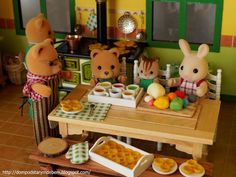 three stuffed animals sitting at a table with food in front of them and on the other side