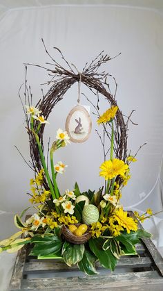 a basket filled with yellow flowers sitting on top of a wooden crate