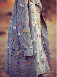 a woman in a dress with flowers on it