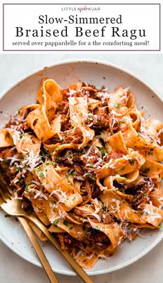 a white plate topped with pasta covered in sauce