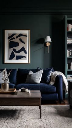 a living room filled with furniture and bookshelves next to a painting on the wall