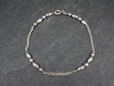 This beautiful estate bracelet is sterling silver. It features a combination of chain and diamond cut beads. Measurements: 3mm wide, 7 wearable inches Marks: 925 Weight: 3.3 grams Condition: Excellent Sterling Silver Chain, Chain Link Bracelet, Bead Bracelet, Diamond Cut, Vintage Sterling Silver, Sterling Silver Chains, Link Bracelets, Chain Link, Silver Chain