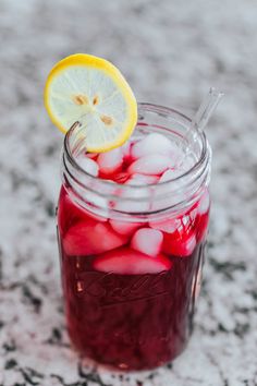 a mason jar filled with ice and lemon slices