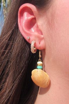 Handmade colorful seashell earrings with real seashells from Myrtle Beach, South Carolina. Earrings are gold and nickel free. Choose from seven different color options to have your very own unique one of a kind pair of real seashell earrings! Gold Beaded Hoop Earrings For The Beach, Shell-shaped Jewelry With Matching Earrings For The Beach, Beachy Shell Dangle Earrings, Yellow Hoop Earrings For Summer Beach, Beachy Gold Dangle Earrings, Gold Dangle Earrings For Beach Season, Yellow Bohemian Hoop Earrings For Beach, Beachy Gold Beaded Jewelry, Bohemian Yellow Hoop Earrings For Beach