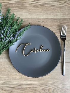 a plate with the word carulee on it next to a fork and knife