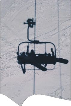 an aerial view of a ski lift in the snow