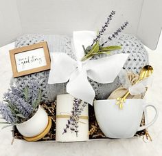 a gift box filled with coffee mugs, teacups and other decorative items