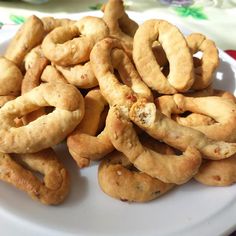 a white plate topped with pretzels on top of a table