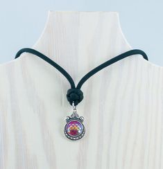 This pink mermaid scale necklace is a must-have for fans of mythical creatures. The charm design includes realistic scales in a gorgeous pink hue nestled inside a round frame with aquatic design. Includes a black 550 paracord with diamond knot and matching barrel closure. Makes a unique gift for mermaid fans and beach lovers! Also available in blue, white, and green scales. CHARMS Pink scale charm is single-sided and crafted from zinc alloy metal and resin. Measures 28 mm long. CHOOSE YOUR SIZE Pink Adjustable Cord Jewelry For Festival, Scale Necklace, Aquatic Design, Green Scales, Paracord Necklace, Diamond Knot, Pink Mermaid, Mermaid Jewelry, Beach Gifts