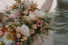 a woman holding a bouquet of flowers in her hands