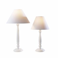 two white table lamps sitting next to each other