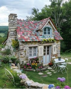 a small stone house with flowers on the roof