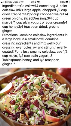 an apple and cranberry coleslaw salad in a wooden bowl