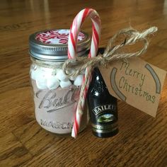 a jar filled with marshmallows next to a bottle of beer