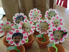 there are many pictures of babys in flower pots on the table with brown paper bags