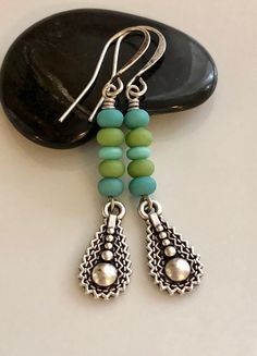 "blue and green glass earrings boho earrings dangle long bohemian earrings Small blue and green matte glass beads were stacked on top of antiqued silver plated teardrop charms. Hook ear wires are antiqued silver plated brass. Length of earrings from top of ear wires is 2 1/4\". Glass beads measure 4mm. Teardrop charm measures 18mm long, not quite 3/4\". You can enter my shop here: gypsydangles.etsy.com" Nickel Free Bohemian Long Drop Earrings, Silver Teardrop Beaded Earrings Bohemian Style, Bohemian Silver Teardrop Beaded Earrings, Bohemian Nickel Free Long Drop Earrings, Bohemian Silver Teardrop Earrings With Dangling Beads, Bohemian Czech Glass Teardrop Jewelry, Bohemian Green Teardrop Earrings With Ear Wire, Bohemian Teardrop Czech Glass Jewelry, Bohemian Sterling Silver Teardrop Beaded Earrings