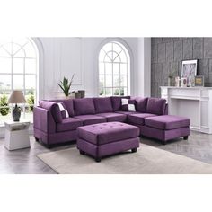 a living room with a purple couch and ottoman