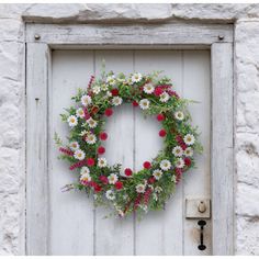 a white door with a wreath on it