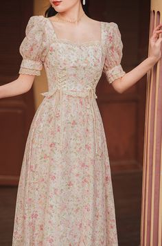 Square neck midi dress with short puff sleeves, lace trims and a lace up corset waist on a floral print and embroidered fabric. Concealed back zipper. S: 33" chest, 26.5" waist, 42.5" lengthM: 34.5" chest, 28" waist, 42.5" lengthL: 36" chest, 29.5" waist, 42.5" lengthXL: 37.5" chest, 31" waist, 42.5" length Square Neck Puff Sleeve Dress, Flower Printed Dress, Square Neck Midi Dress, Floral Dress Outfits, Lace Neck, Frock For Women, Lace Up Corset, Corset Waist, Modest Dresses Casual