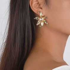 A pair of flower-shaped stud earrings featuring shimmering stones and an 18k gold-plated finish. 1.53" W x 1.77" L 18k gold-plated copper / cubic zirconia Flower Stud Earrings, Flower Stud, Flower Plates, Flower Earrings Studs, Flower Studs, Cubic Zirconia, 18k Gold, Gold Tones, Copper