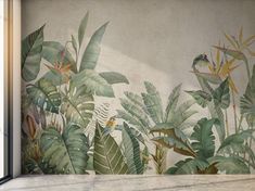 the wall is decorated with tropical plants and birds