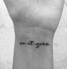 a woman's wrist tattoo with the words so it goes written in black ink