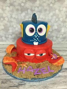 a birthday cake that looks like an octopus with big eyes and a hat on top