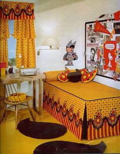 a bedroom with yellow curtains and orange bedspread, black cat pillows, and pictures on the wall