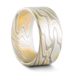 "This set of 10mm Mokume Gane wedding rings are shown in the Twist pattern and the 18k version of our Flare metal combination with a flat profile and an etched finish. The Flare palette features 18k yellow gold, palladium and sterling silver. The first ring also features five flush set stones, one yellow sapphire and four lovely repurposed diamonds provided by the customer. We love having the opportunity to create special pieces like these rings to celebrate new memories with recycled materials! Etched Yellow Gold Bands For Gift, Yellow Gold Etched Bands For Gifts, Modern Etched Jewelry For Wedding, Etched Yellow Gold Bands As Gift, Yellow Gold Etched Bands As Gift, Luxury Etched Ring Jewelry, Gift Yellow Gold Etched Bands, Modern Etched Ring Jewelry, Carved White Gold Ring