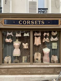 an old fashion store front with mannequins and bras in the window