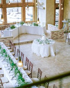 an indoor wedding venue with tables and chairs