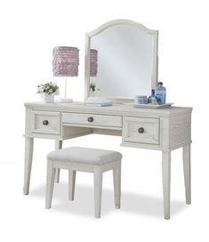 a white dressing table with a stool and mirror