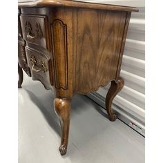 an old wooden dresser sitting on top of a white floor