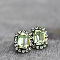 our Mint green Super Sparklers mini rhinestone halo emerald cut stud earrings are made with rare vintage original D&S co. Swarovski Crystals. These lovely halo stud earrings are just delicious! These will add lots of colour when you need a little more sparkle.  D E T A I L S: * Made with rare vintage original 1950's D&S co. Swarovski crystals in mint green chrysolite with a light mint green rhinestone mini halo. * Earrings measure 15mmL or a little over a 1/2'L and come with a large plastic and surgical steel backing to hold these firm to your ears and also a butterfly clutch for your choice of backing. * Set in antiqued brass with a surgical steel post, hypoallergenic for most. * All items are ready to give, boxed and bowed to perfection. * Nickel Free * Looking for a larger quantity for Emerald Cut Stud Earrings, Mint Green Earrings, Halo Stud Earrings, Butterfly Clutch, Light Mint Green, Halo Earrings, Halo Earrings Studs, Steel Post, Earrings Crystal