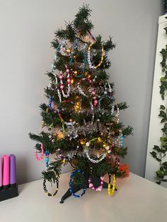 a small christmas tree decorated with beads and lights