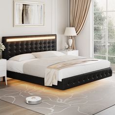 a bedroom with a bed, night stand and nightstands in white and black colors