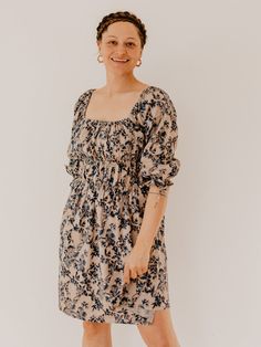 This romantic cotton dress features elastic details across the bodice and pretty ties at its ruffle cuffs. The modern silhouette is juxtaposed with a textile that celebrates centuries old artisanal techniques - a rich floral fabric, block printed by hand. Fit Note: True to size 100% cotton Hand block printed fabric Elastic smocked bodice Self tie cuff detail Length of size M is 31" from top of bodice Made fair trade in India by one of our longstanding production partners This textile has been pr Flowy Spring Dress With Elastic Sleeves, Casual Dresses With Gathered Neckline For Gatherings, Spring Dresses With Elastic Sleeves For Casual Occasions, Spring Dresses With Elastic Sleeves For Dress Down Occasions, Puff Sleeve Dress With Gathered Sleeves For Gatherings, Chic Cotton Dresses With Bishop Sleeves, Casual Dress With Smocked Back For Gatherings, Elegant Spring Peasant Dress With Puff Sleeves, Bohemian Midi Dress With Gathered Sleeves For Spring