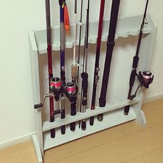 there are many fishing rods on the shelf