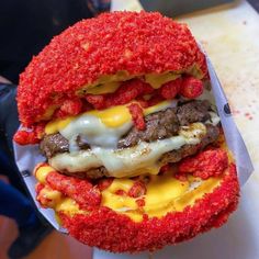 a hamburger covered in cheese and meat