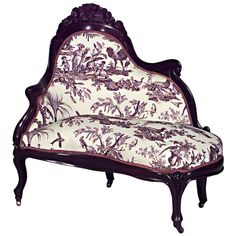 an ornately decorated couch sitting on top of a white floor