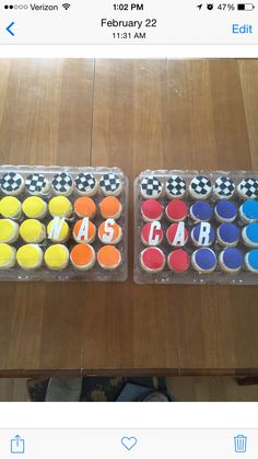 two cupcakes that are sitting on top of each other with letters painted on them