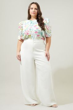 Effortless and feminine. This blouse features a dainty pastel floral print that shapes the Beverly top. Features a ruched detail long the side sleeve to create a draped effect. It frames a classic fit that can be worn tucked into trousers. A keyhole closure sits at the nape of the neck.- Drape sleeve - Classic fit- Keyhole- Color: White MultiSize + Fit - Model is 5'8" and wearing size 2X- Measurements taken from size 2X - Chest: 25 1/2"- Length: 28" Fabric Self: 98% Polyester 2% Spandex Lining: White Ruched Short Sleeve Blouse, Feminine Puff Sleeve Blouse For Garden Party, White Ruched Blouse For Brunch, Chic White Ruched Blouse, White Tops With Gathered Sleeves For Brunch, Feminine White Blouse With Floral Print, White Ruched Blouse For Spring, Ruched White Blouse For Spring, White Feminine Blouse For Garden Party