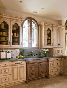 a large kitchen with wooden cabinets and marble counter tops, along with tile flooring